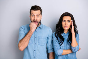 frantic worried couple wondering what to do