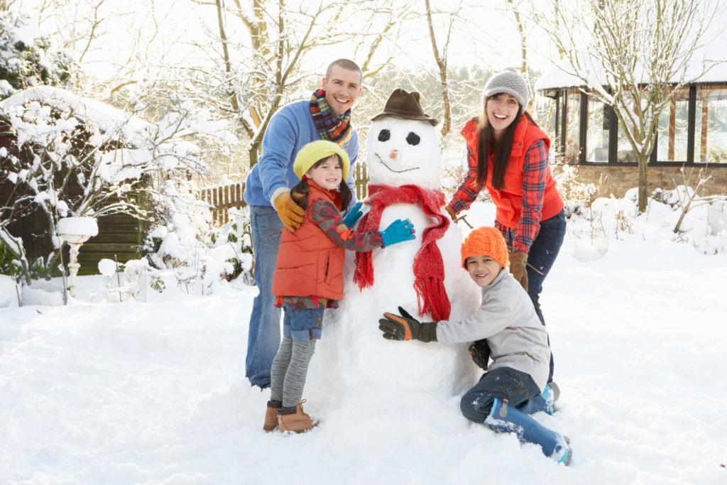 Family building a Snowman