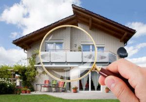 Hands with Magnifying Glass on House