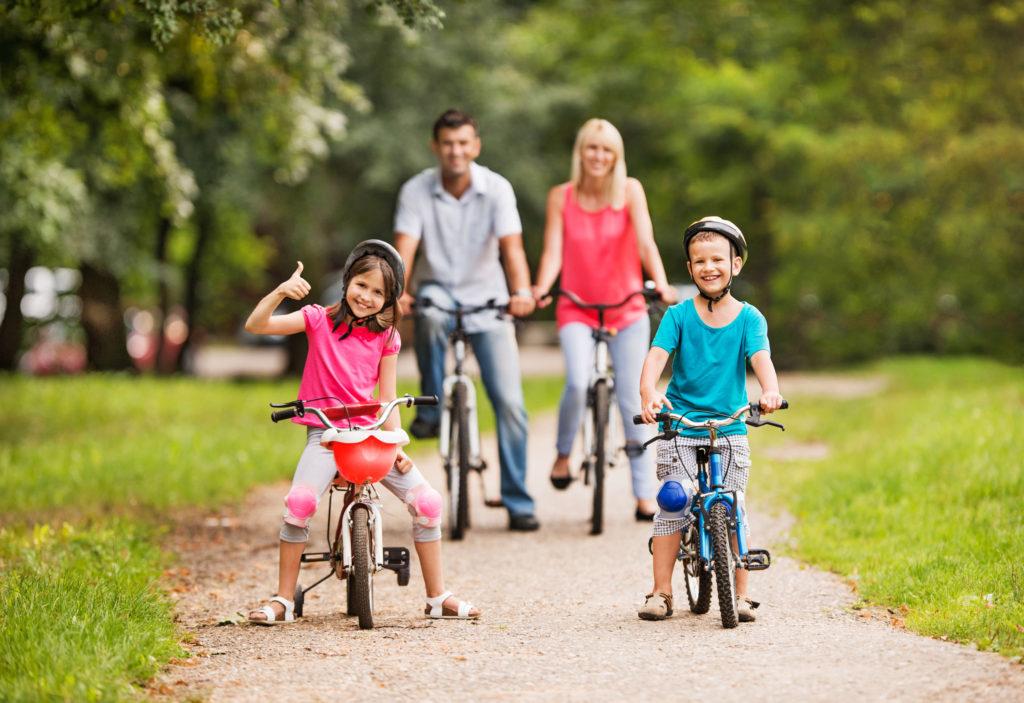 Family Riding on Bikes in a Park
